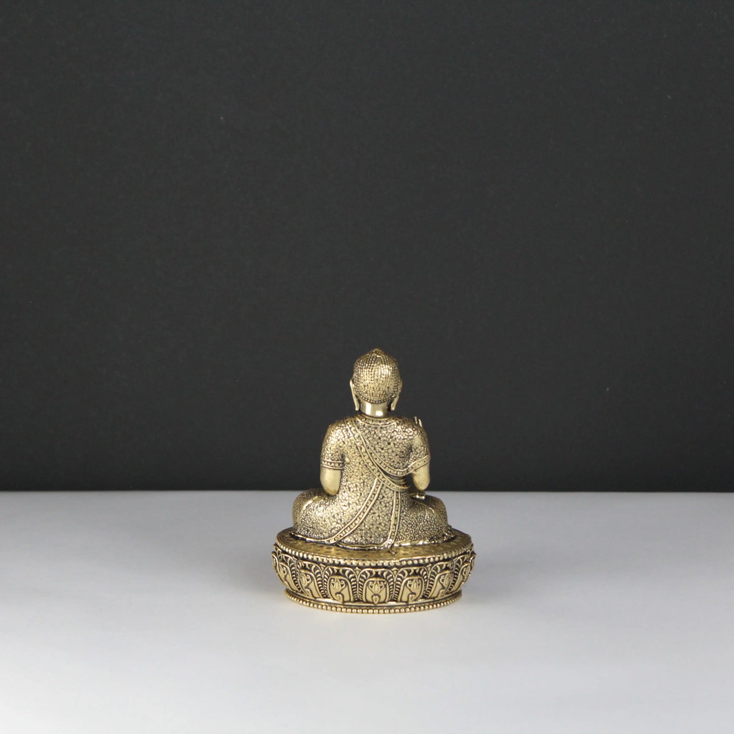 Gold Buddha statue on a dark background