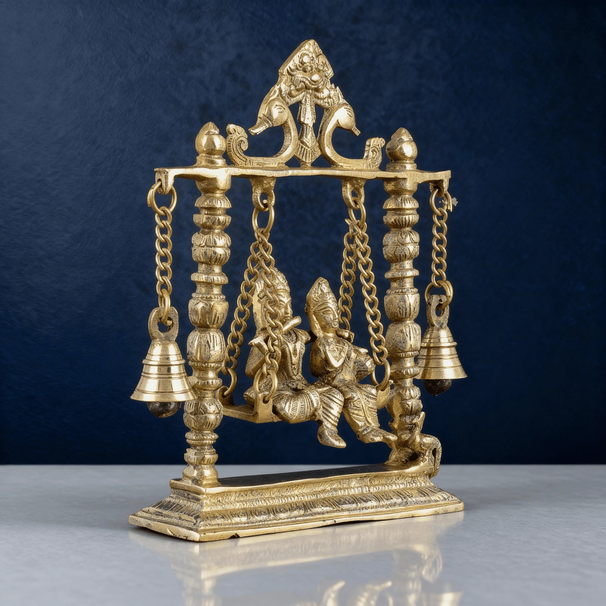 Back view of pure brass Radha Krishna swing idol showing detailed carving work, traditional Indian handcrafted decorative statue.