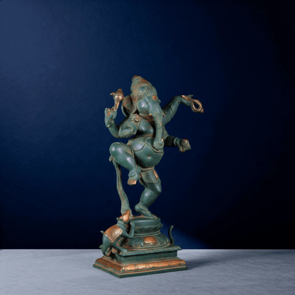 Side perspective of vintage-finish Ganesha sculpture in dance pose with supporting mouse companion