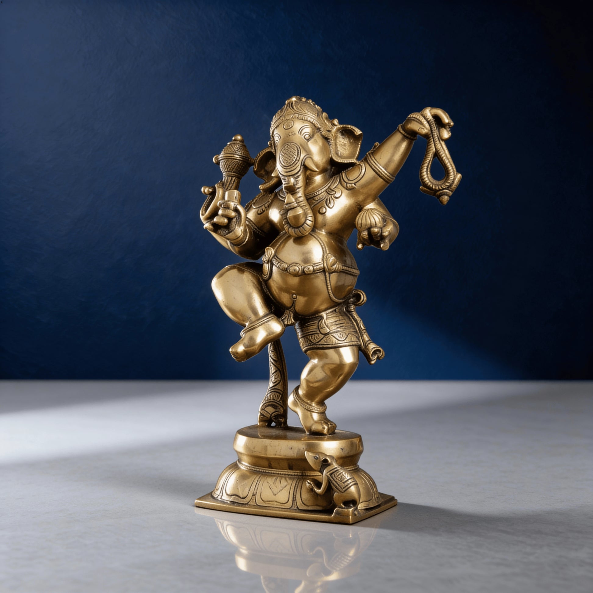 Angled close-up of brass Lord Ganesha statue in classical dance posture with raised leg