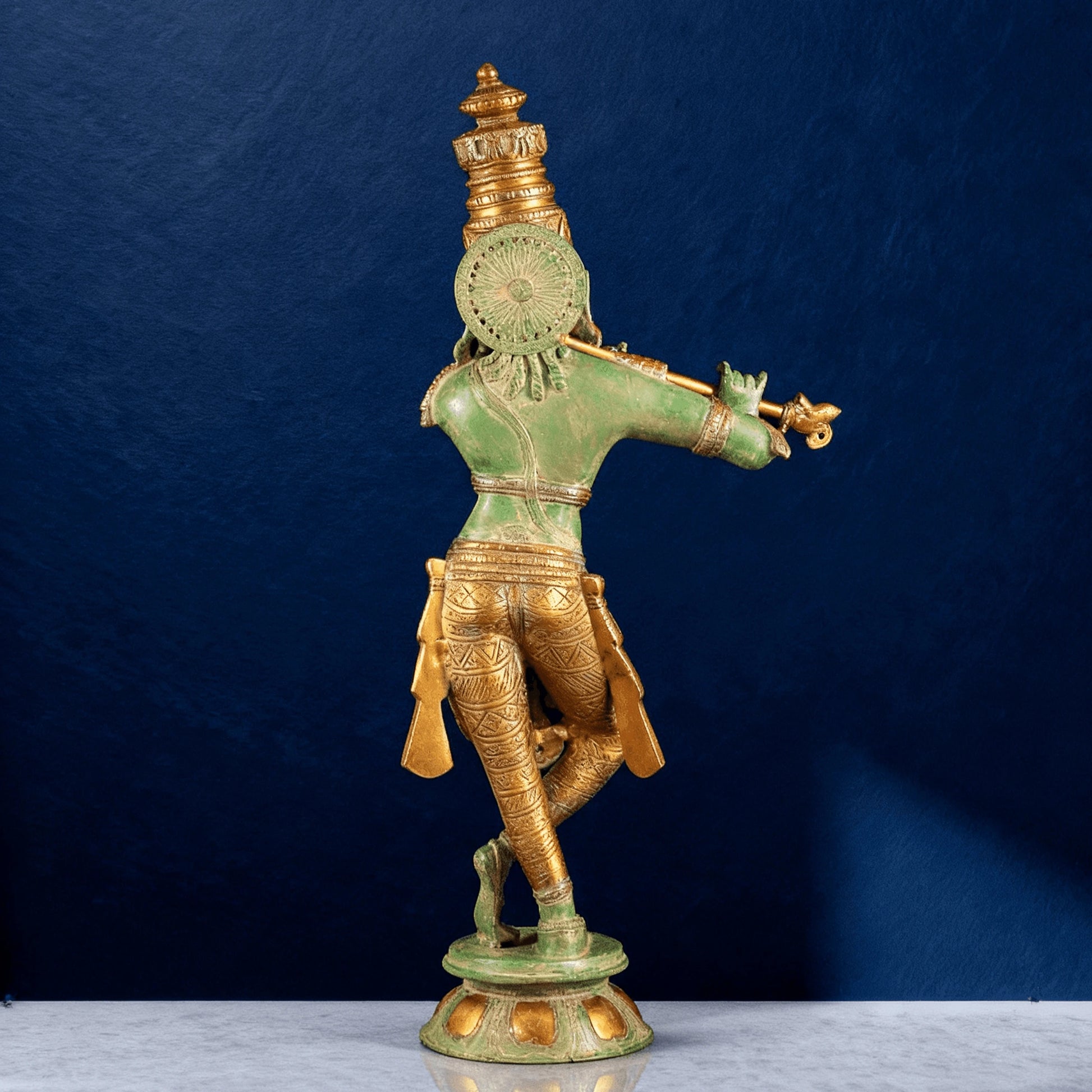 Back profile of brass Krishna murti with intricate detailing