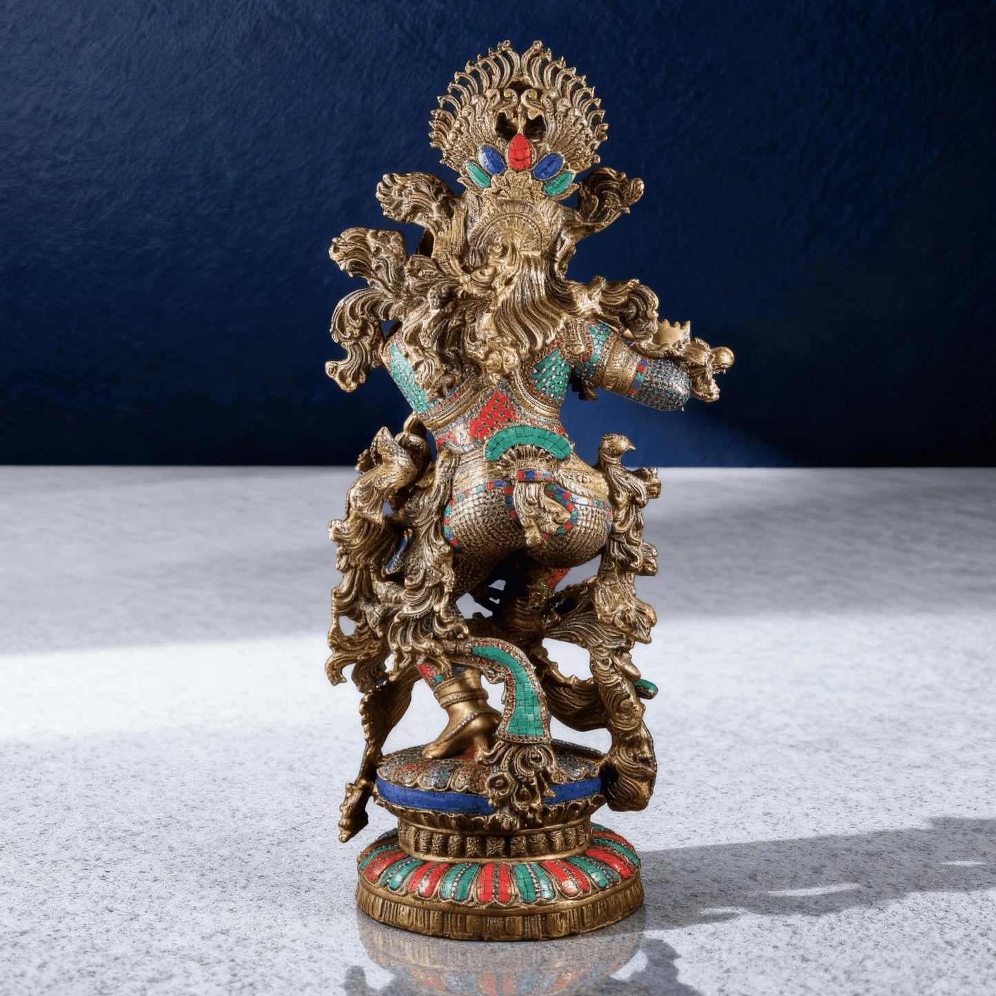 Back view of multicolor stone-studded brass Krishna idol