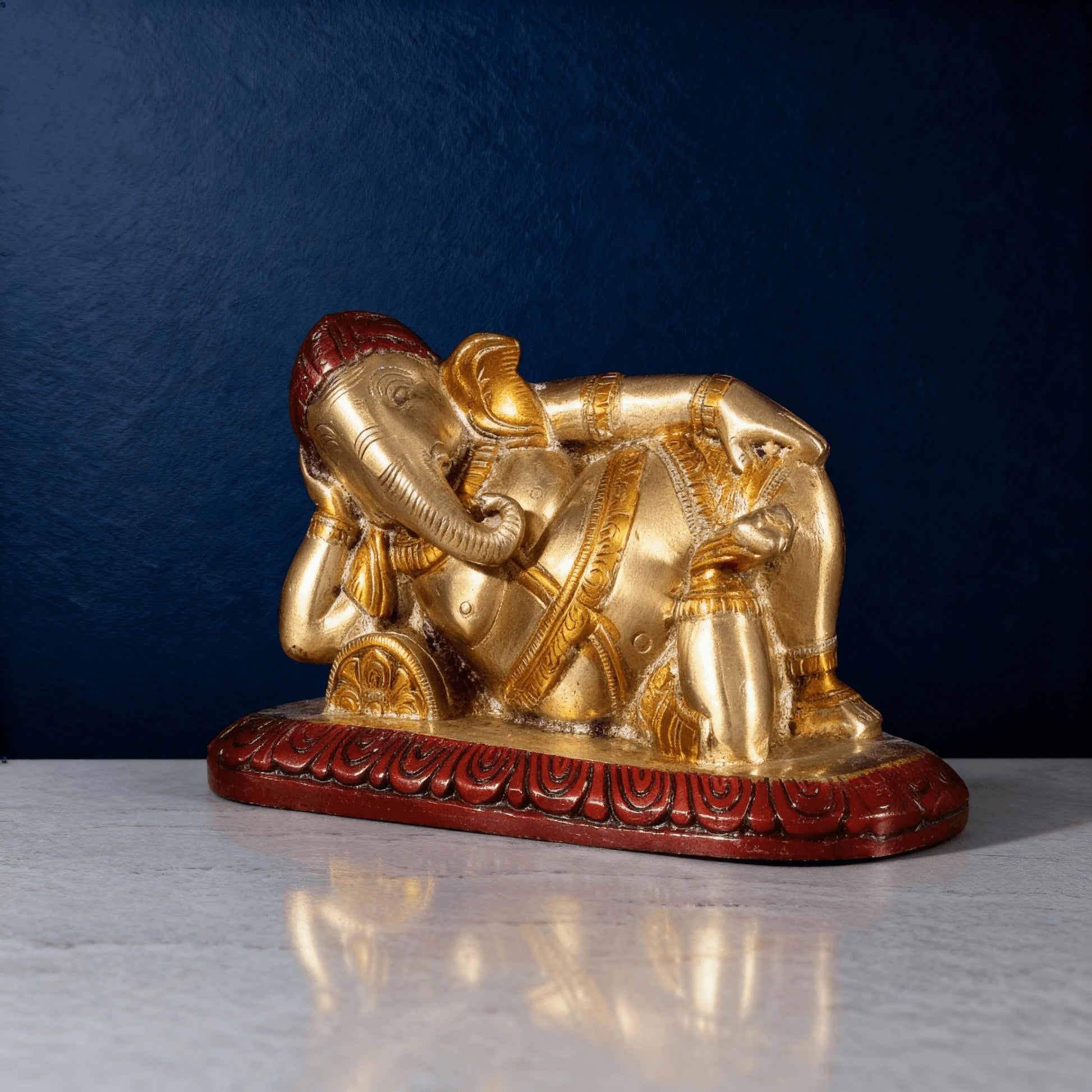 front angled view reclining brass ganesha murti