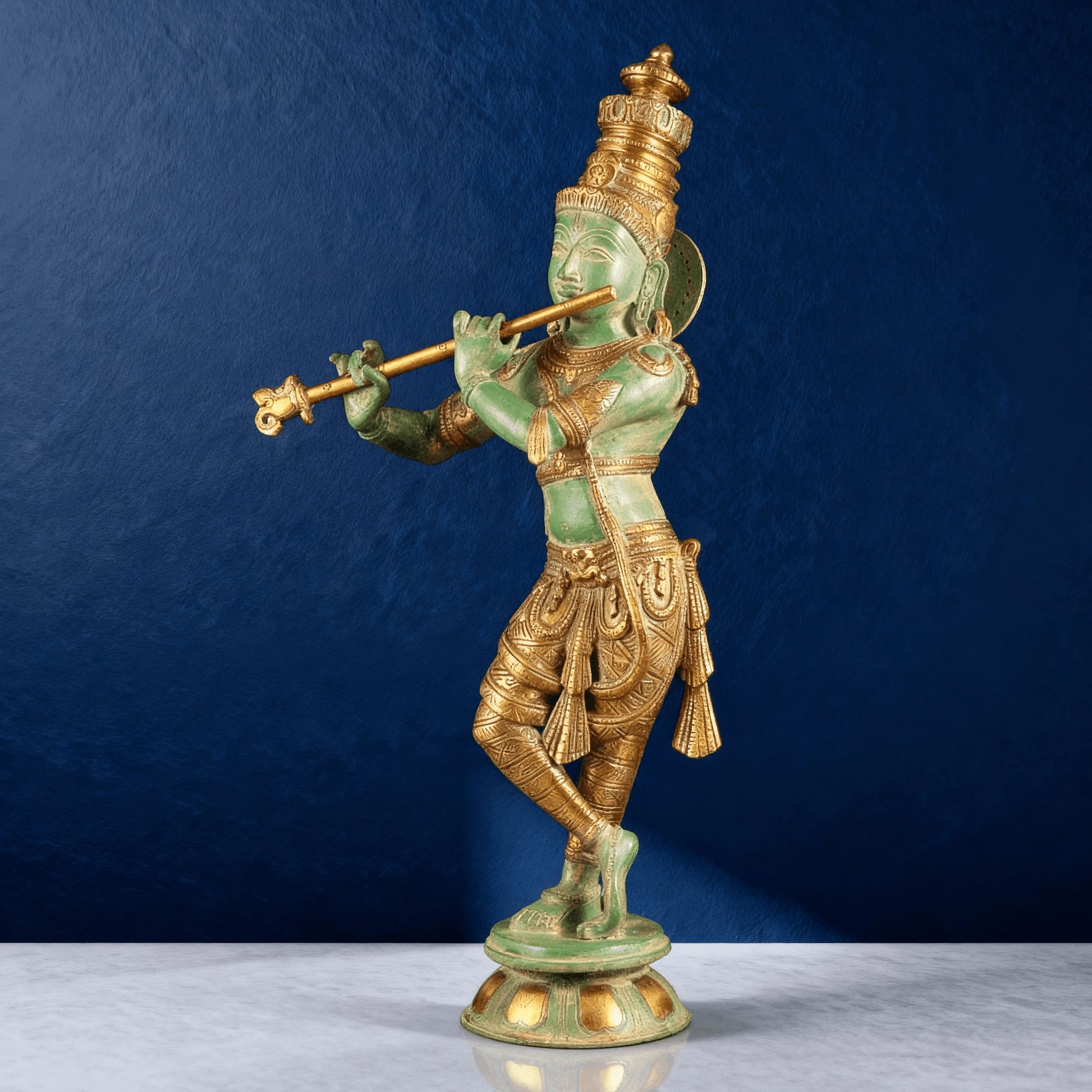 Brass Krishna statue with green antique finish playing flute