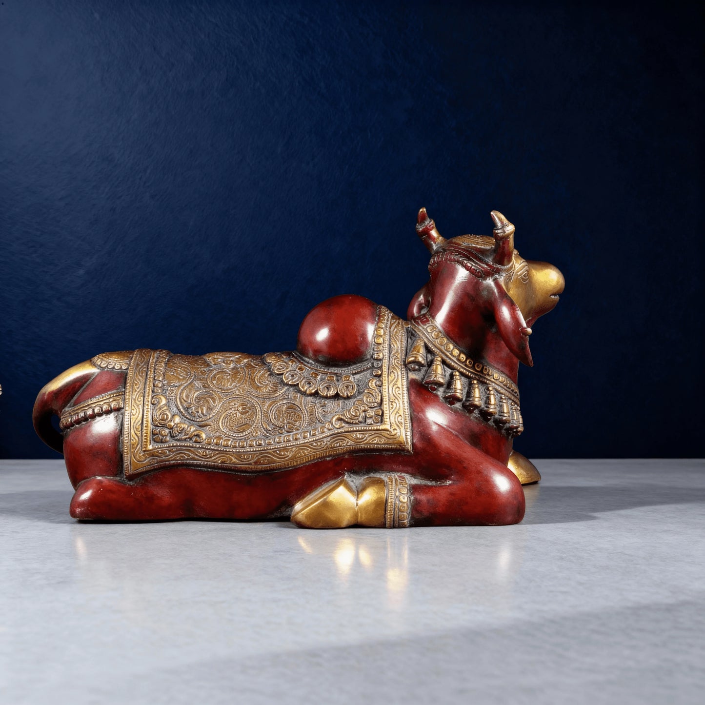 Brass Nandi figurine rear-side angle showing ornate carving and red finish