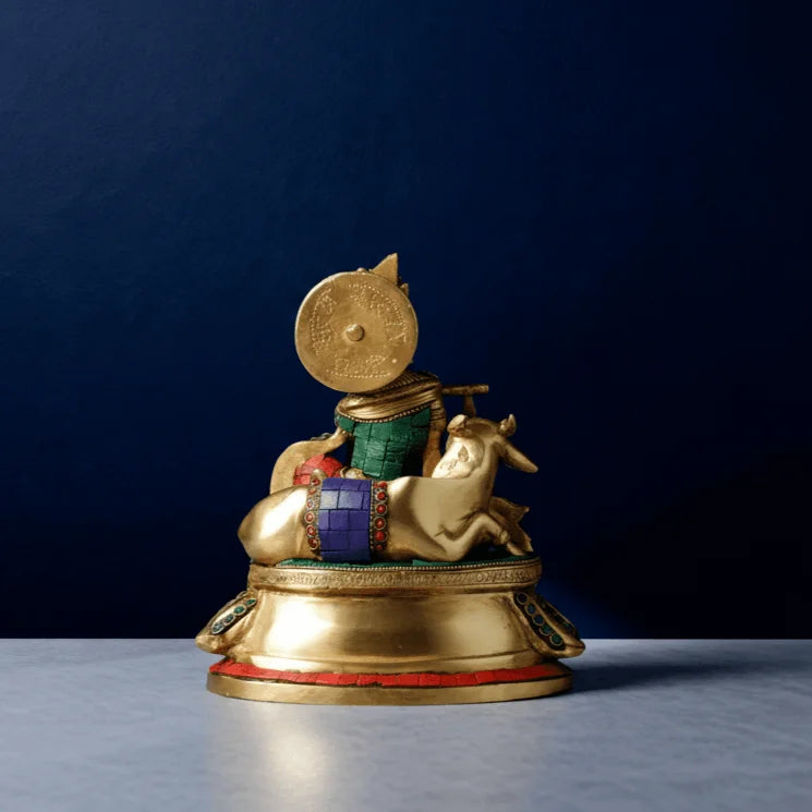 Brass Krishna idol back view with cow and shield, handcrafted stone inlay and antique finish on circular base