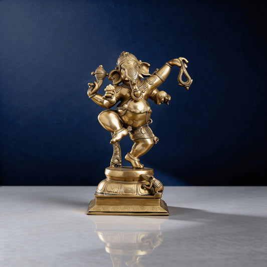 Front view of shiny brass Ganesha murti in dancing pose with detailed ornaments and mouse figure