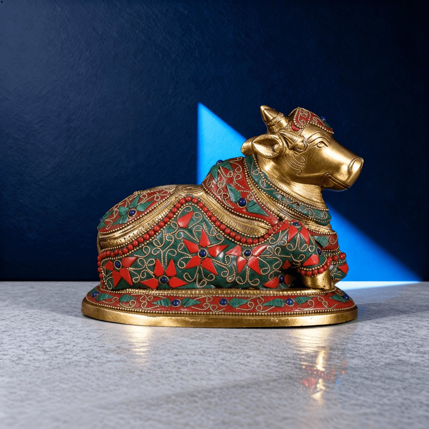 handcrafted brass nandi statue with vibrant meenakari work under studio lighting