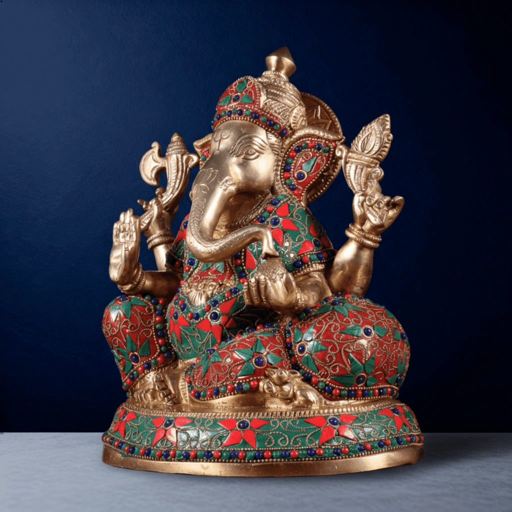Brass Ganesha idol side angle with detailed stonework