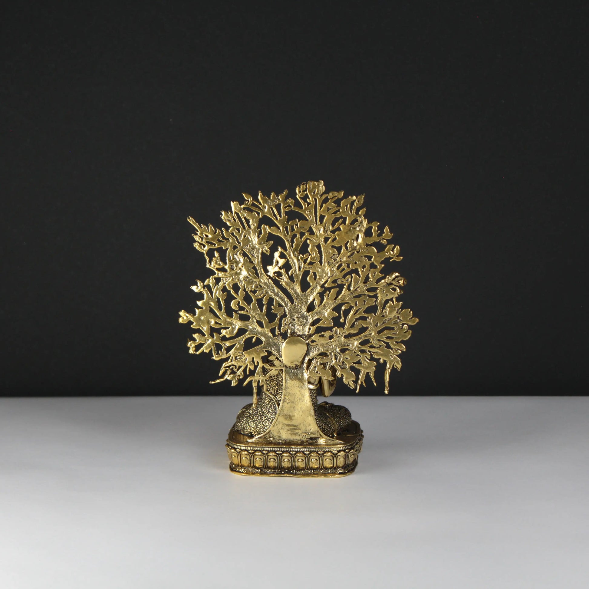 Gold tree-shaped decorative object on a black and white background