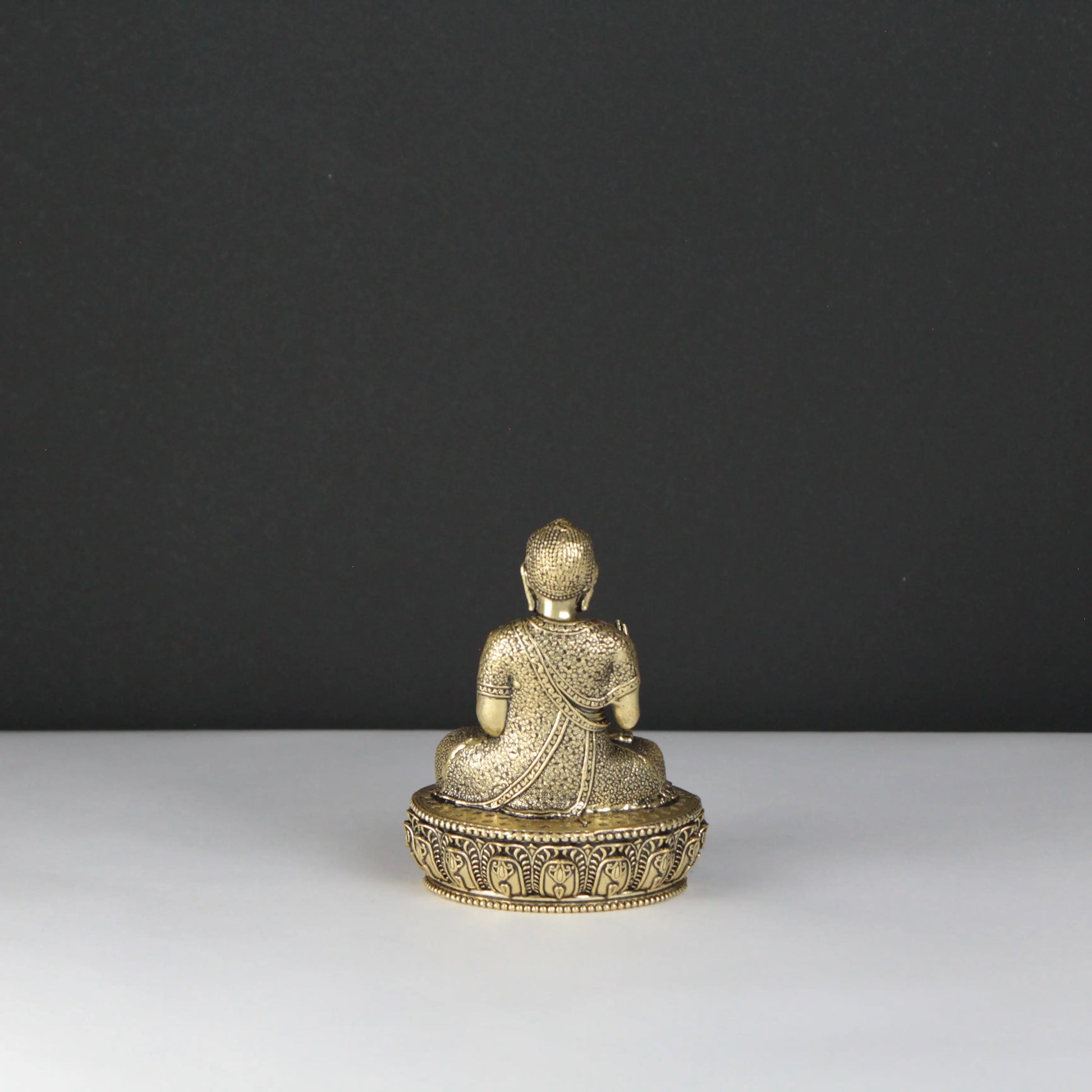 Gold Buddha statue on a dark background
