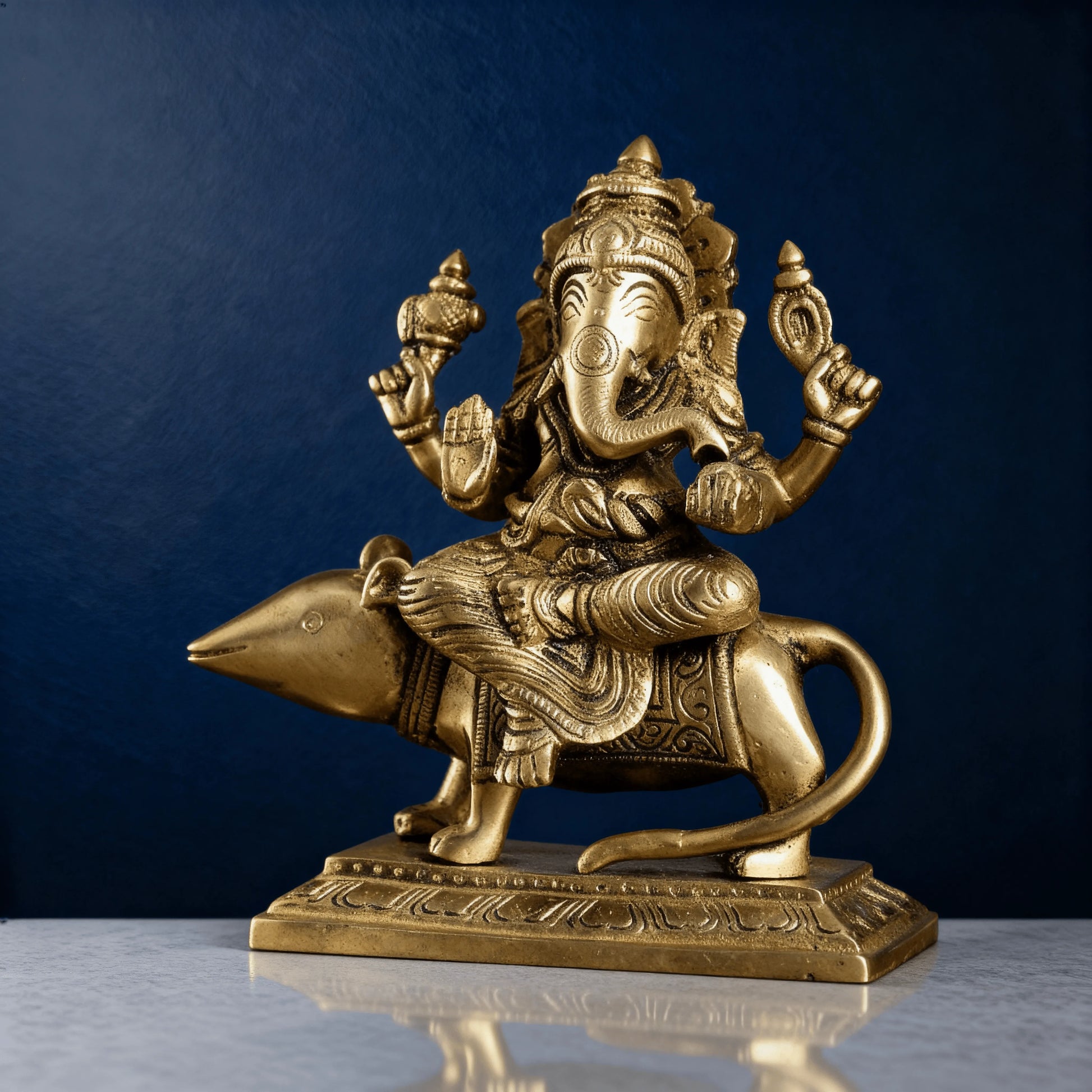 Brass Ganesha on mouse idol angled side view with detailed carvings