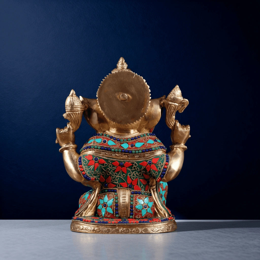 Back view of brass Ganesha idol with detailed turquoise and red stone inlay