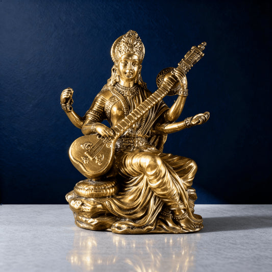 front-facing brass Saraswati statue seated on a sculpted base, showing clean detailing and warm metallic shine in studio lighting