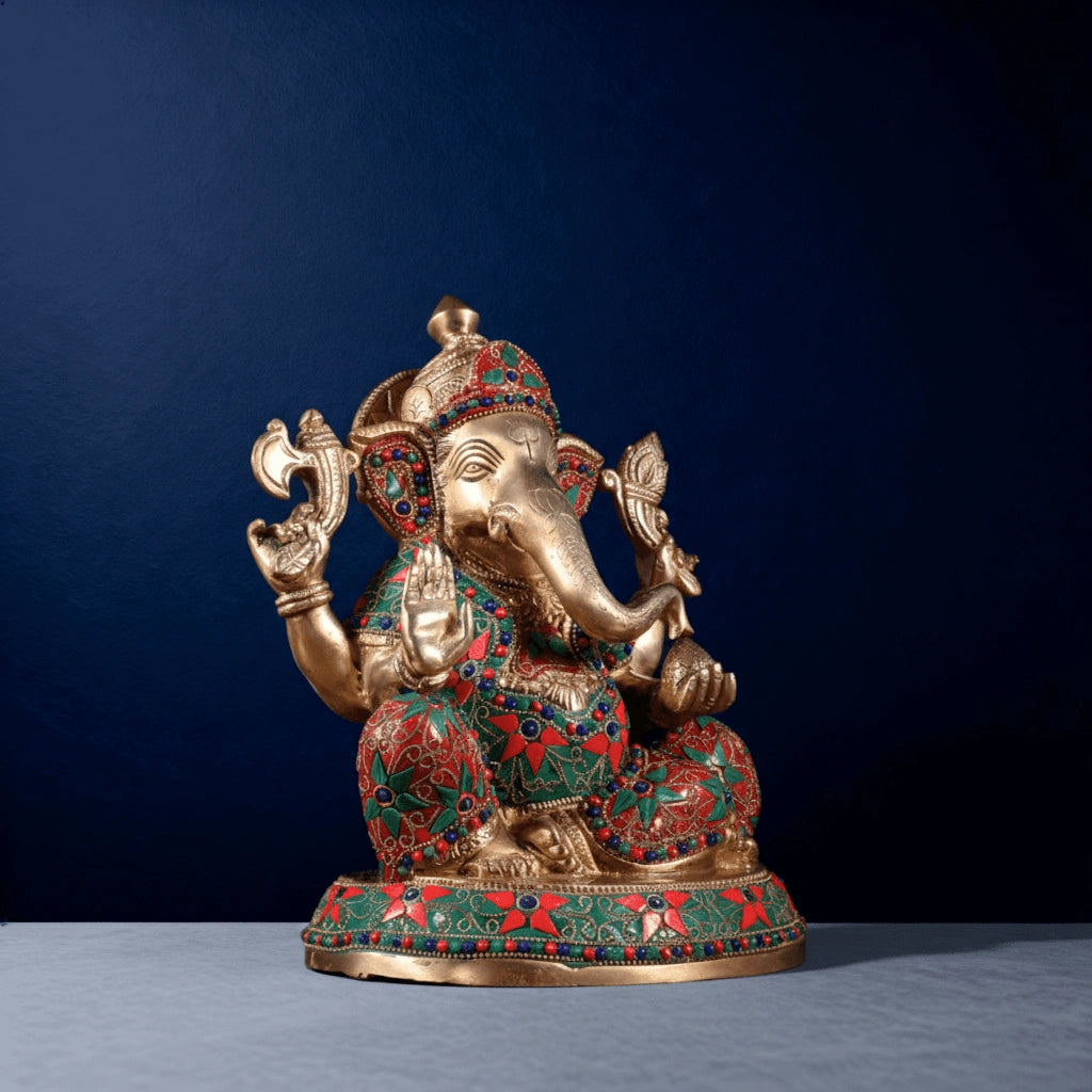 Colorful stone-studded brass Ganesha statue on studio background
