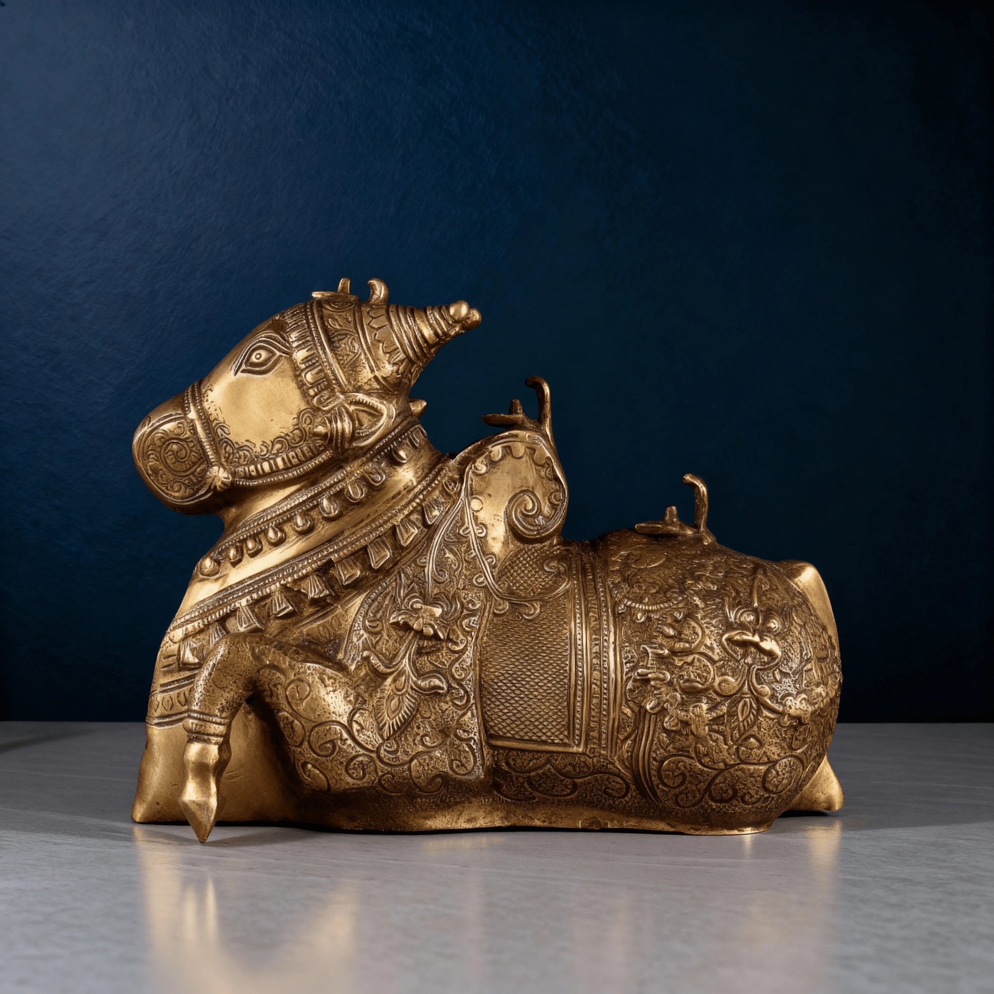 Detailed left-angle shot of ornate brass Nandi idol