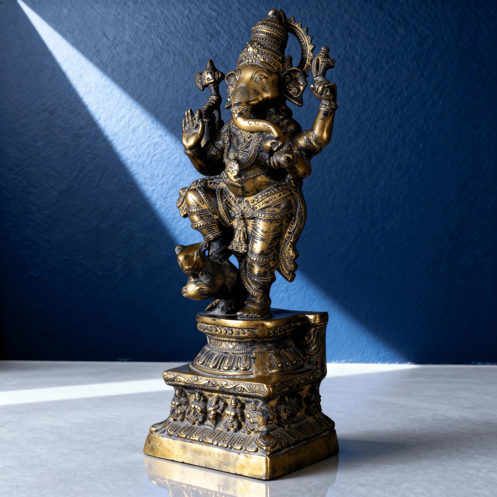 Antique brass Nataraja Ganesha statue dancing on mouse vehicle with intricate carvings on decorative pedestal