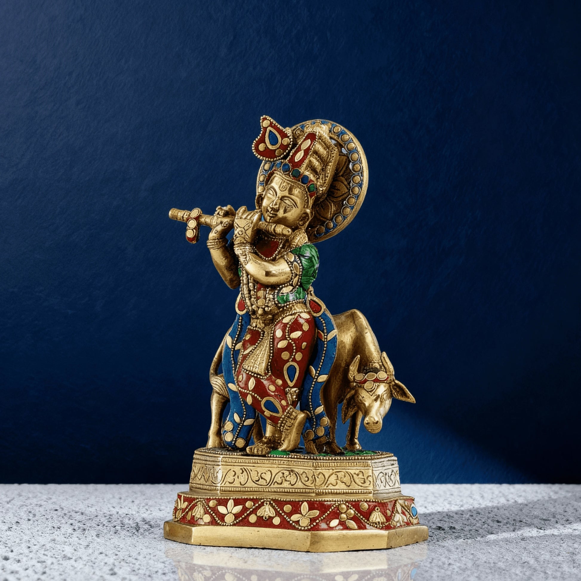 Pure brass Krishna and cow statue with colorful meenakari stonework and intricate detailing on a raised base for home decor
