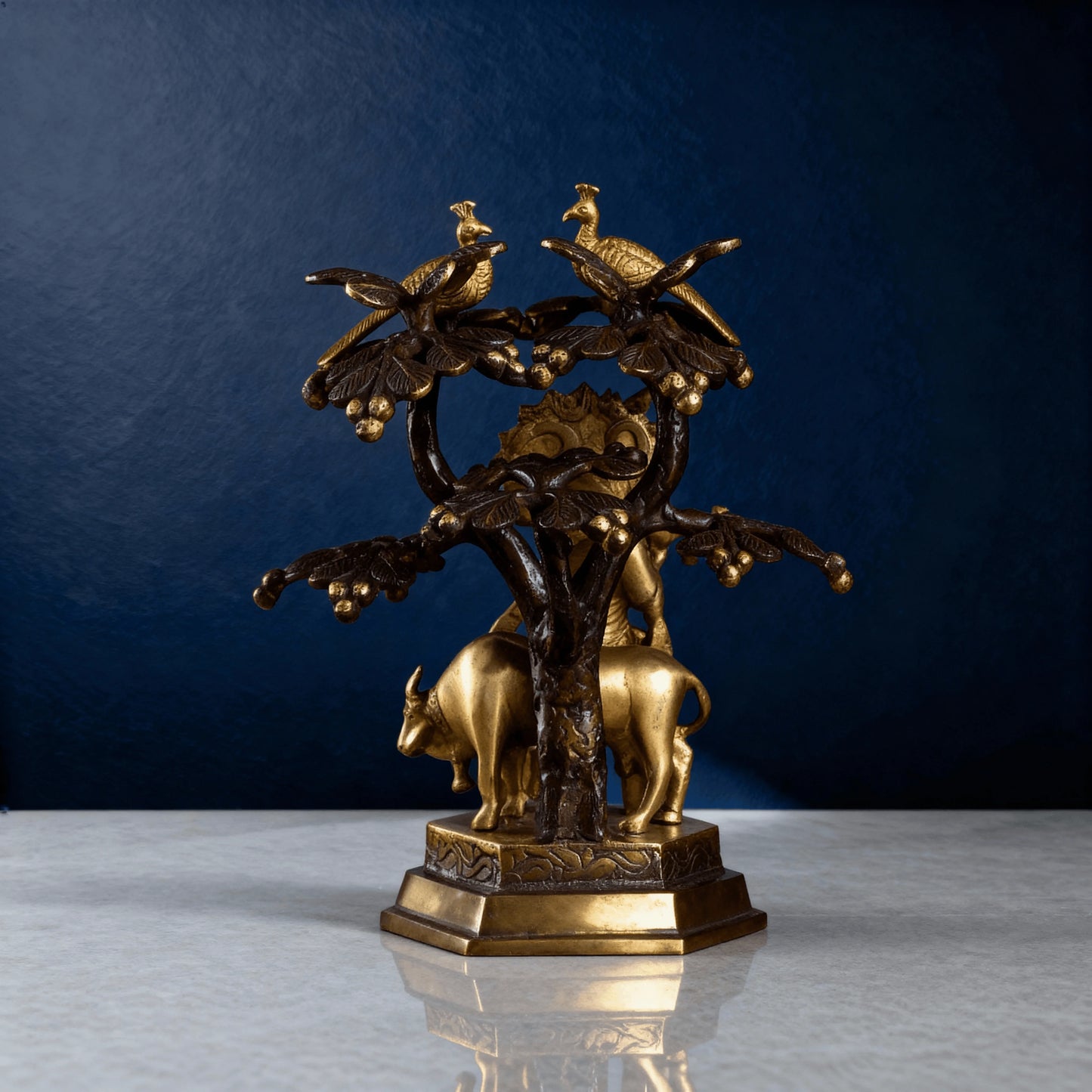 Rear view of brass Krishna sculpture with tree and peacocks – traditional Hindu religious artwork