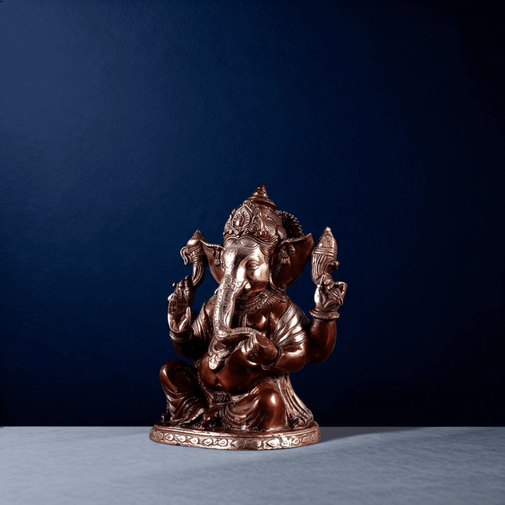 Three-fourth angle of handcrafted brass Ganesha statue with detailed crown and decorative base for interior decor