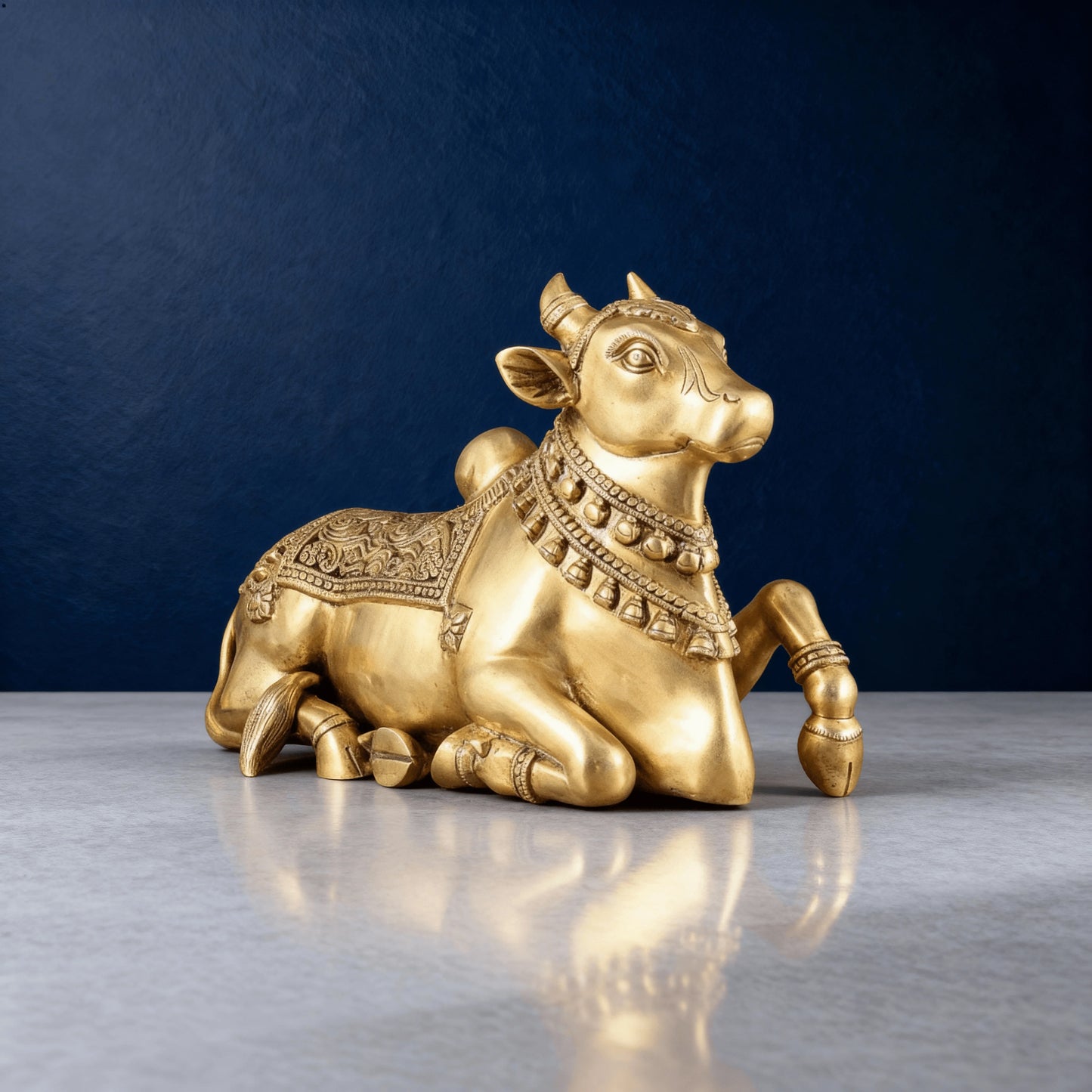 Close-up angled view of brass Nandi showcasing detailed facial features and artwork