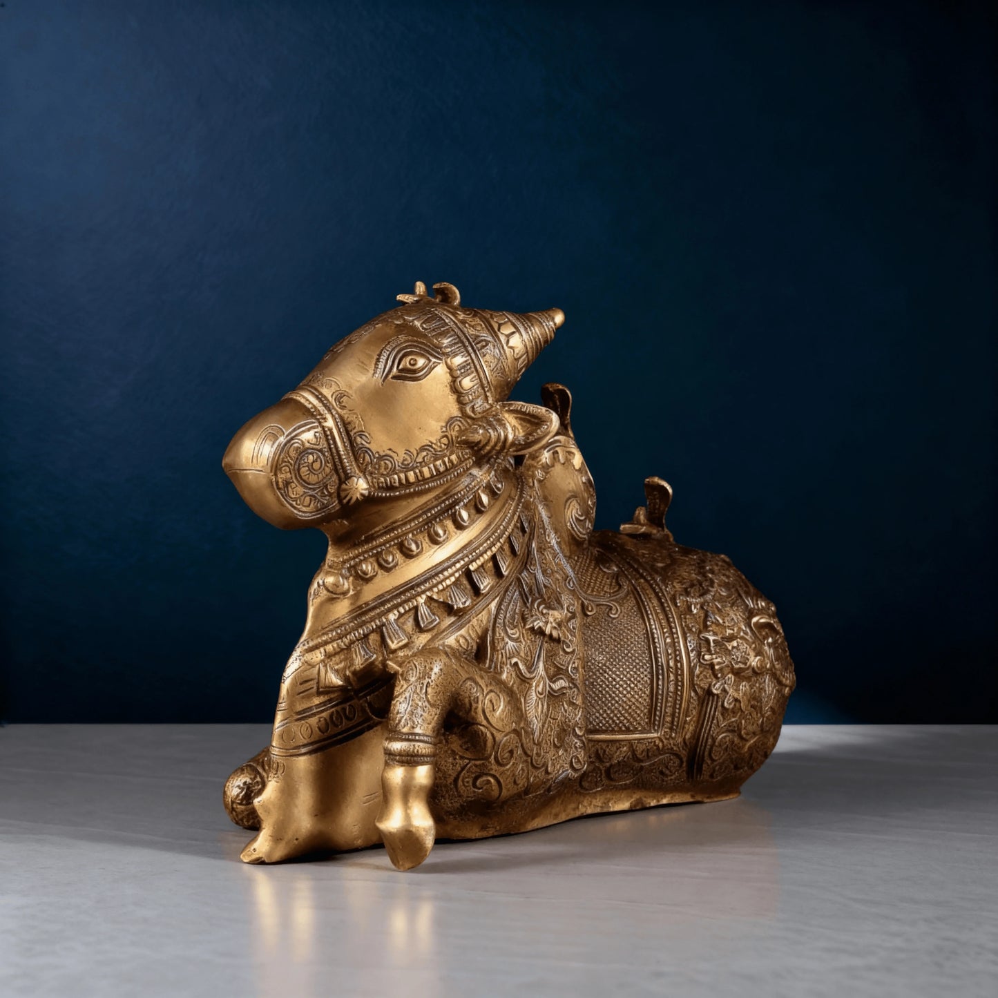 Handcrafted antique-finish brass Nandi statue photographed in studio lighting